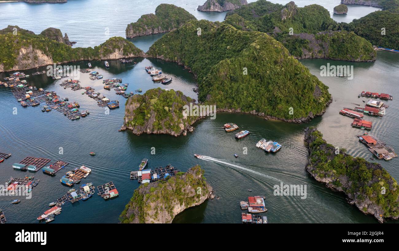 Floating fishing village and rock island in " Lan Ha " Bay, Vietnam, Southeast Asia. UNESCO