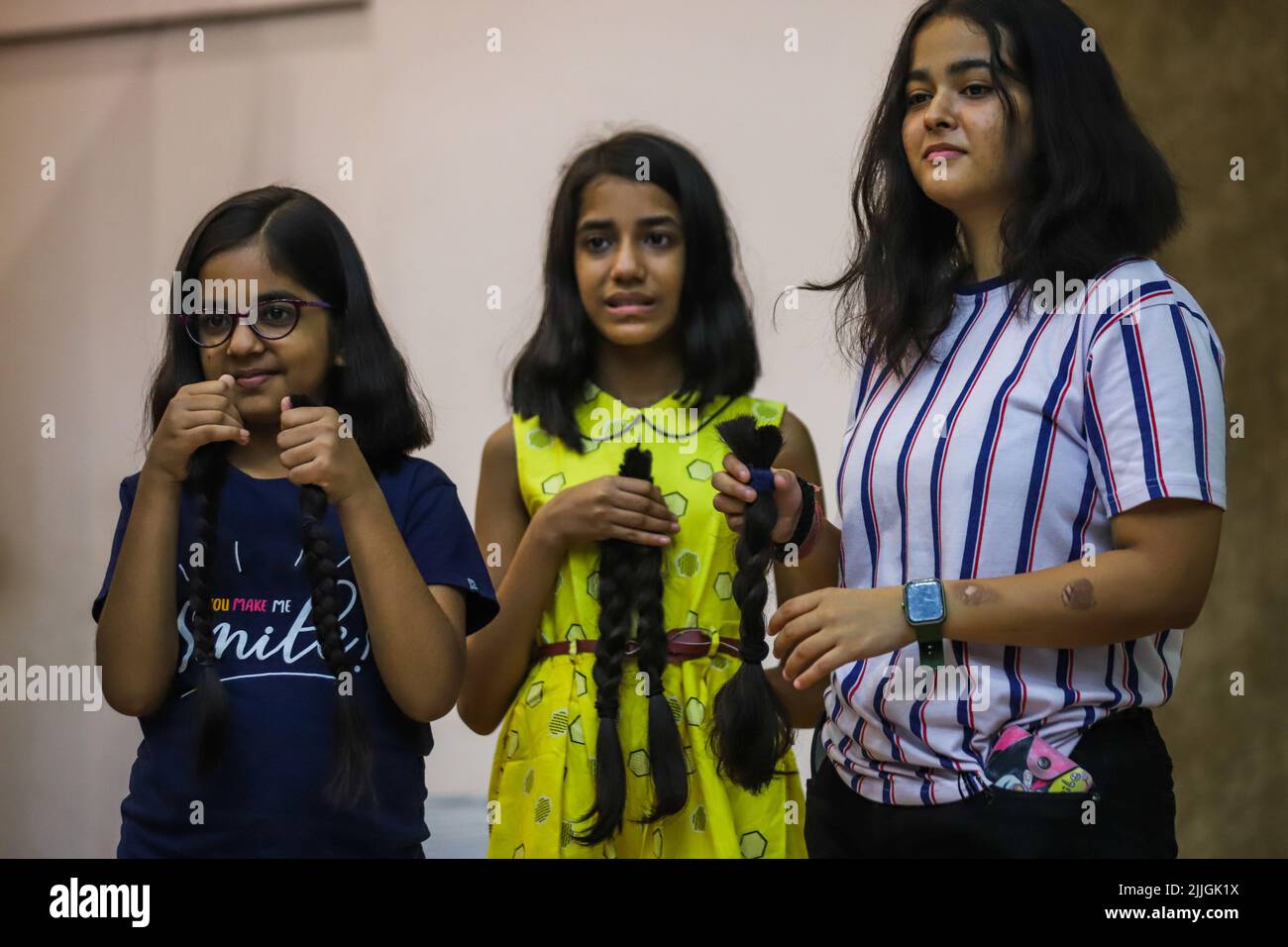 New Delhi, India. 24th July, 2022. Young volunteers show their hair locks  after snipping off during a donation drive to support cancer survivors,  organized by Hair for Hope India foundation's Cut-a-thon event