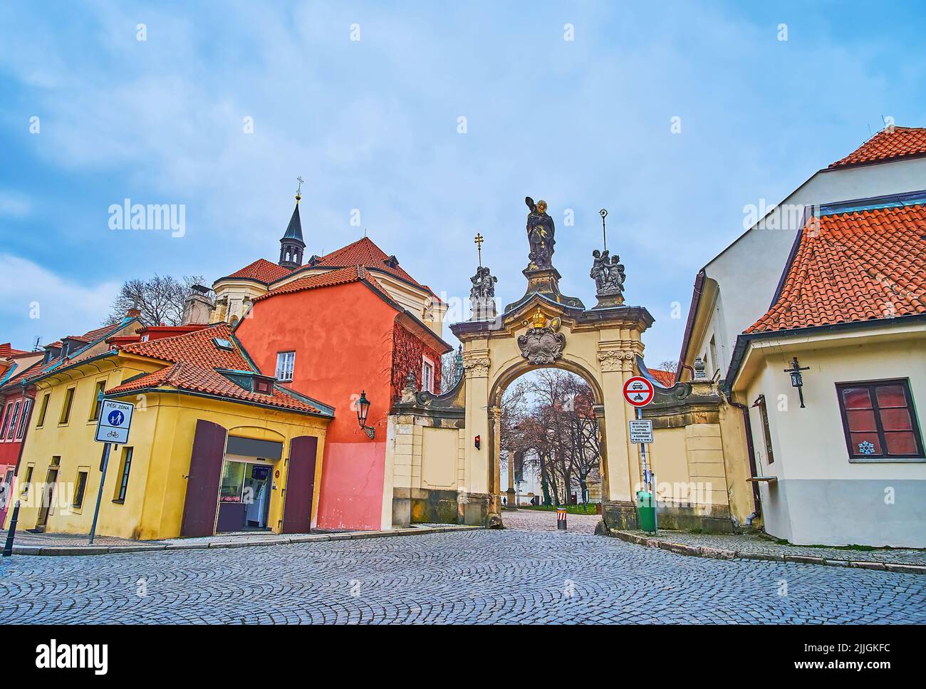 The carved sculptured gate of Strahov Monastery, surrounded with houses ...