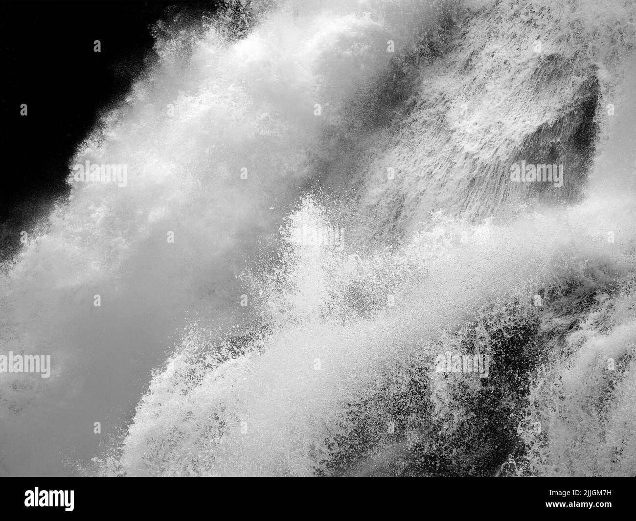 Moving water of the Krimml Waterfalls (Krimmler Wasserfälle). Rocks and water. Austrian Alps. Europe. Fine art black and white. Stock Photo