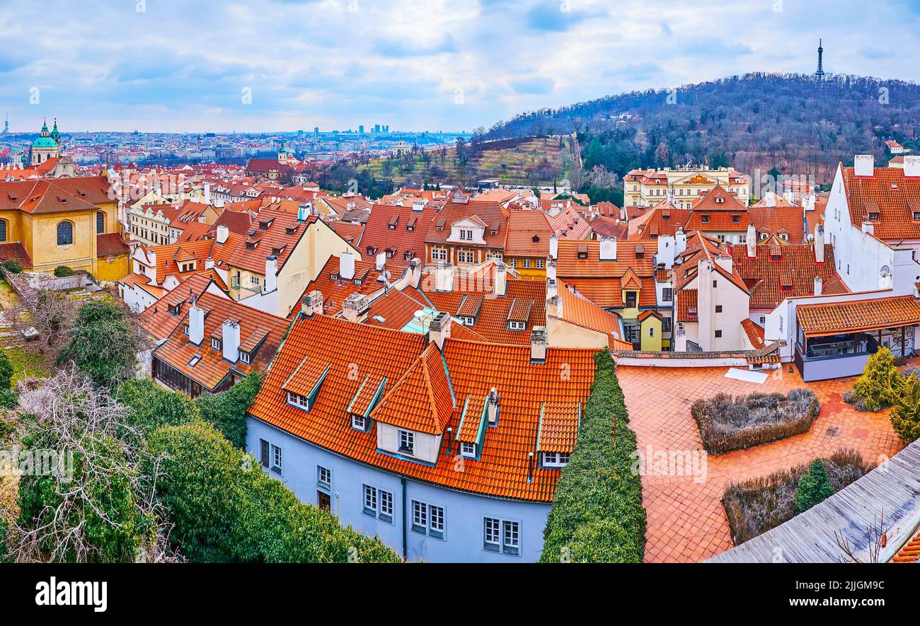 Panorama of the Lesser Quarter (Mala Strana) red tile roofs and the Petrin Hill with lush trees and modern Petrin Lookout Tower, Prague, Czech Republi Stock Photo