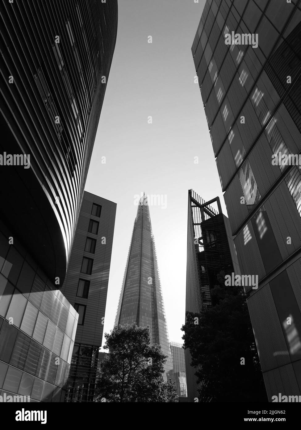 London, Greater London, England, June 22 2022: Looking through buildings on the south bank towards The Shard Skyscraper. Monochrome Stock Photo