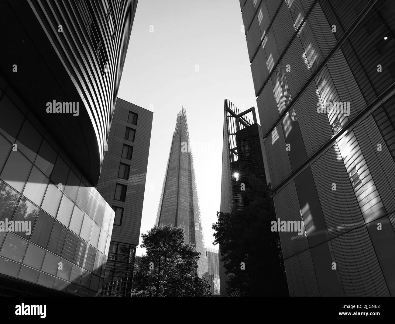 London, Greater London, England, June 22 2022: Looking through buildings on the south bank towards The Shard Skyscraper. Monochrome Stock Photo