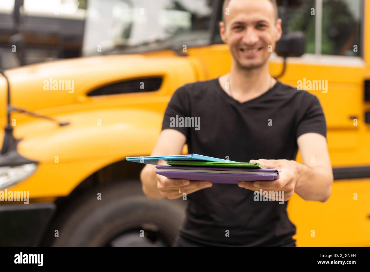 Portrait of young teacher near the school bus Stock Photo - Alamy