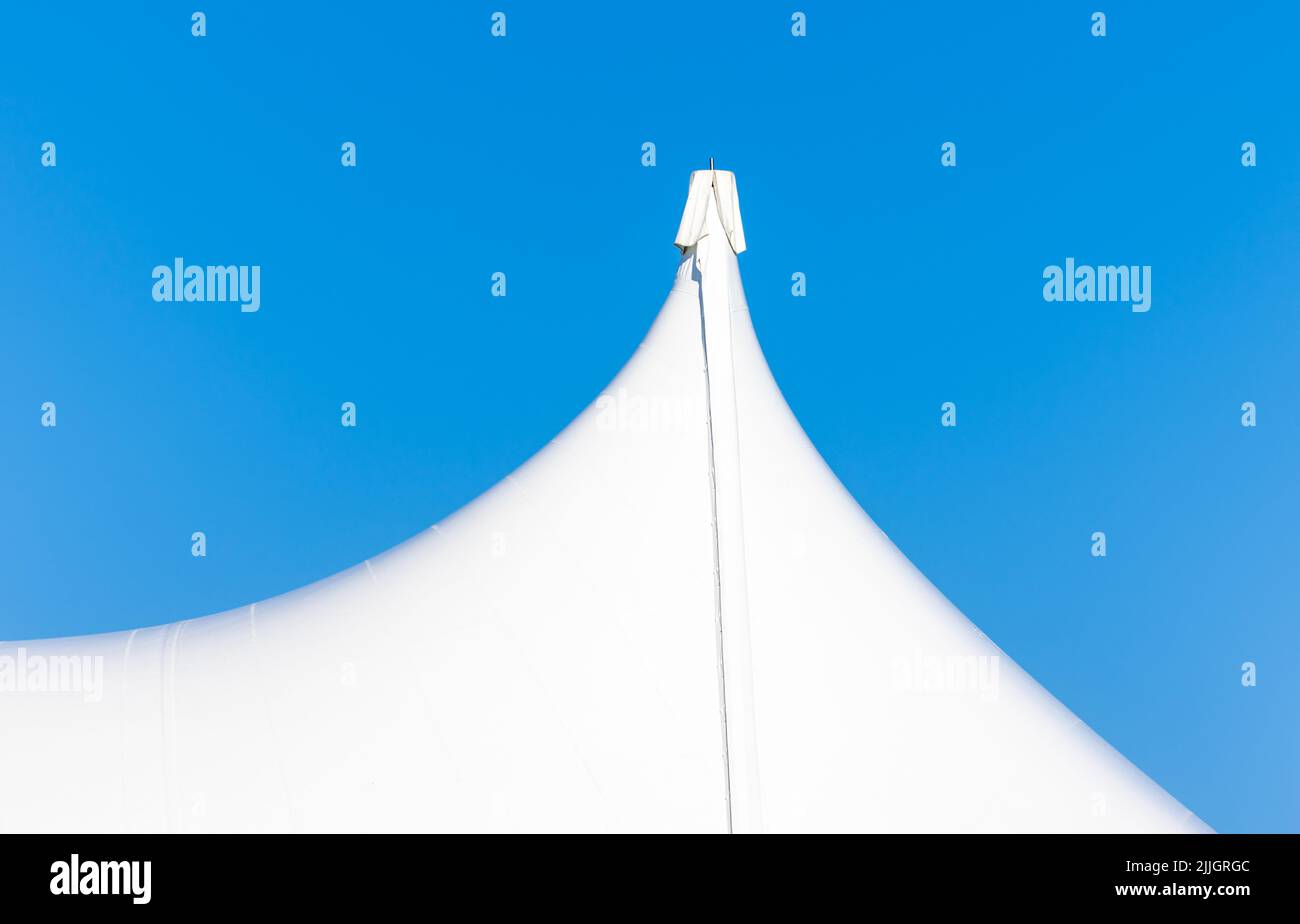 Detail image of a large tent against a blue sky Stock Photo