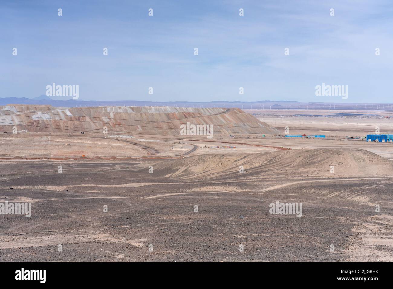 Mine tailings pile behind the Division Ministro Hales or DMH open pit copper mine at Chuquicamata, Chile. Stock Photo