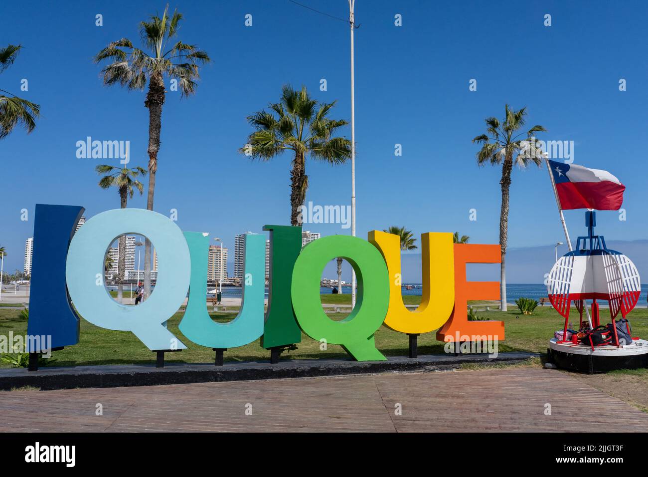 Decorative Iquique sign by a navigation buoy with Chilean flag on the ...