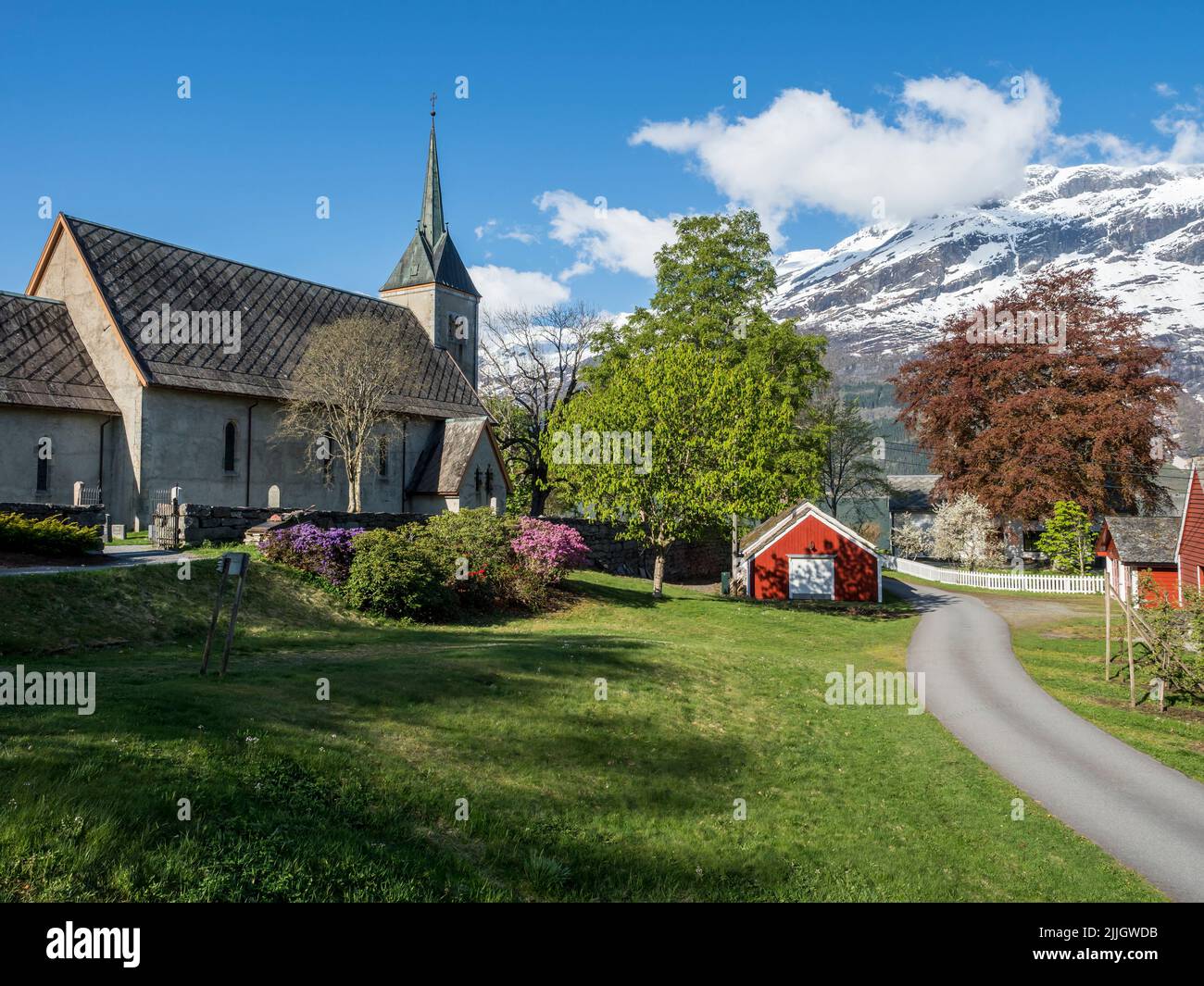 Church of Ullensvang near Lofthus, Hardangerfjord, springtime, snowy mountain, Norway Stock Photo