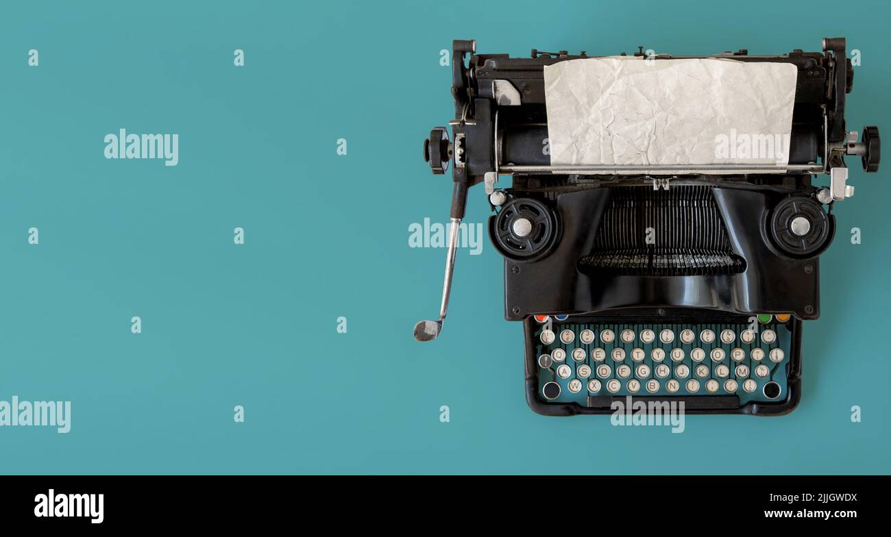 A vintage typewriter on blue background. Stock Photo
