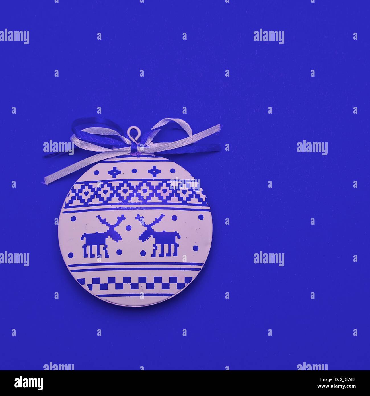 Merry Christmas New Year greeting card with scandinavian ornaments deers. Flat lay white blue christmas minimalist round bauble toy in nordic style ov Stock Photo