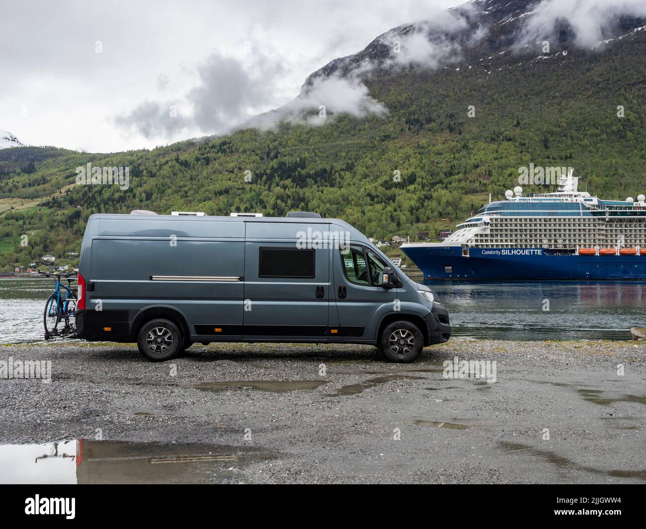 Camper van in front of cruise ship, Sognefjord at village Olden, Norway Stock Photo