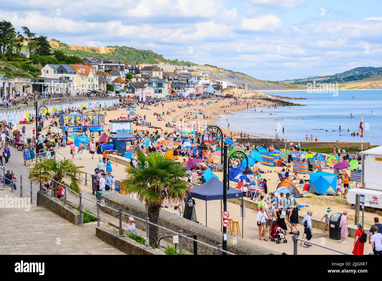 Lyme Regis, Dorset, UK. 26th July, 2022. UK Weather: Families and staycationers soak up the lovely warm sunshine at the seaside resort of Lyme Regis. Holidaymakers are set to more enjoy more glorious weather as hot and sunny weather makes a welcome return towards the weekend. Credit: Celia McMahon/Alamy Live News Stock Photo
