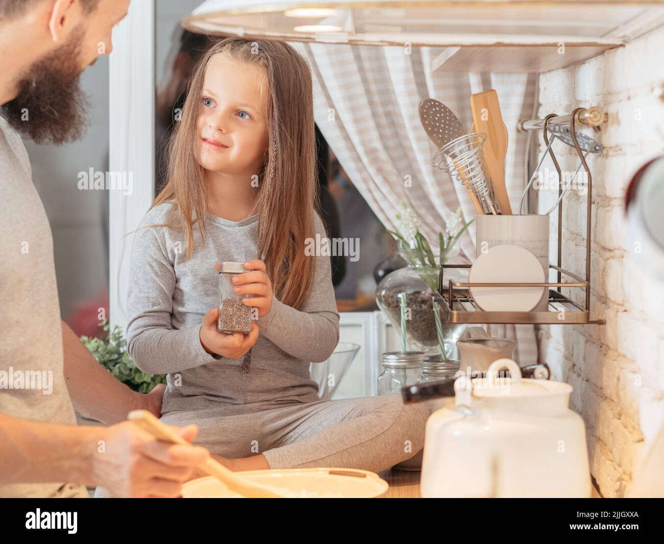 happy family father daughter teaching cooking Stock Photo