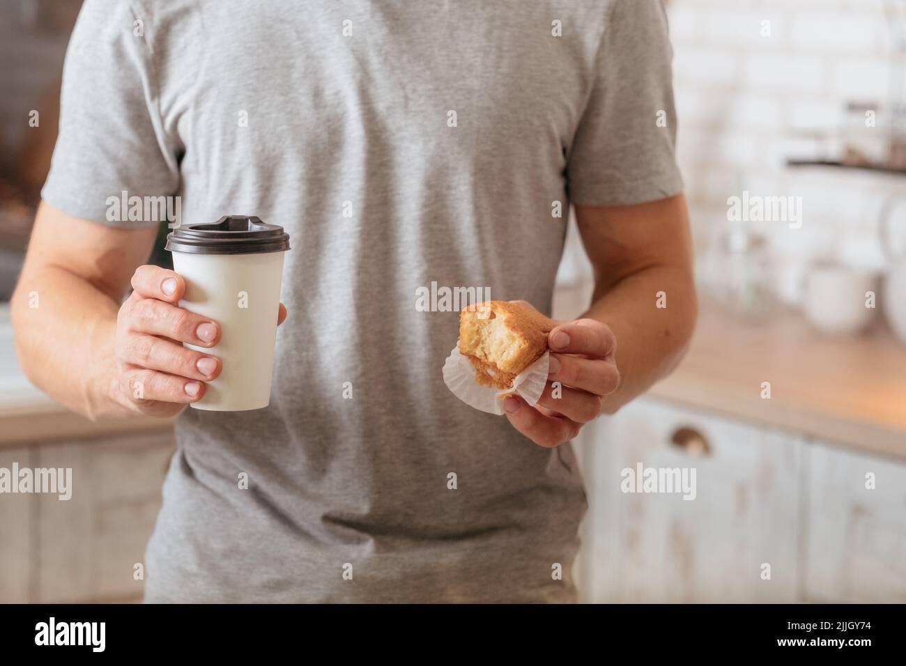 morning habit man eating muffin coffee breakfast Stock Photo Alamy