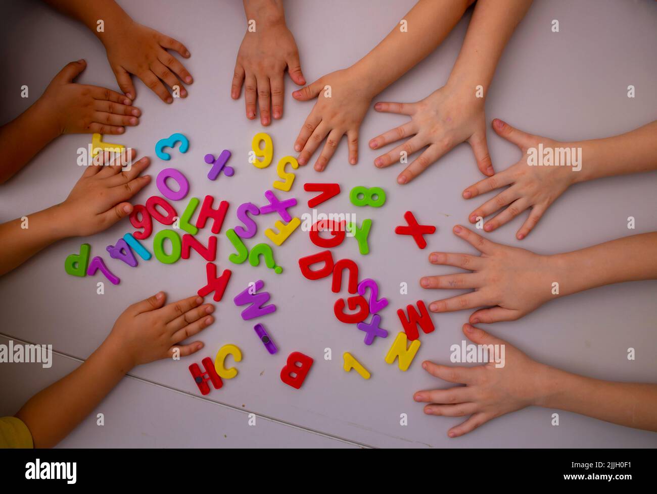 kids-hands-and-english-letters-top-view-learning-concept-stock-photo