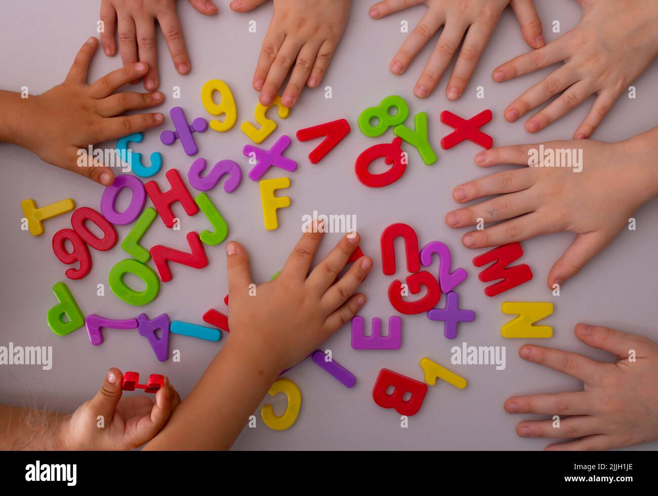 Preschoolers learning letters, english alphabet. top view Stock Photo