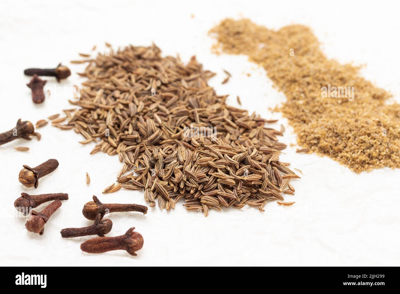 Clove spice buds, fennel seeds and ground coriander. Close up. Top view