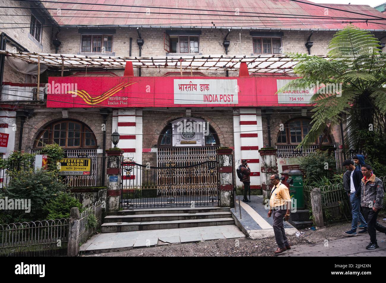 People walk past the Darjeeling head post office (HPO) on a busy