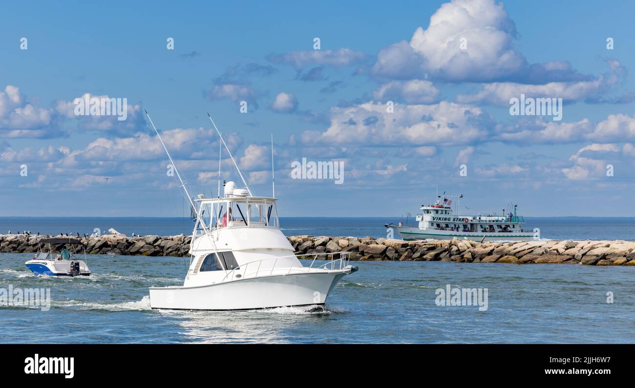 Boats coming and leaving Montauk Harbor Stock Photo