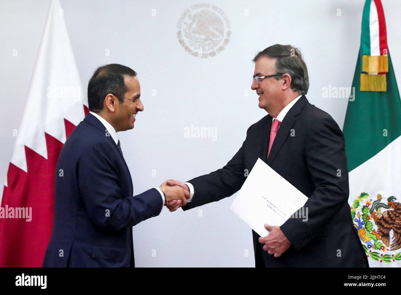 Qatar’s Foreign Minister, Mohammed bin Abdulrahman bin Jassim Al Than, and Mexico’s Foreign Minister, Marcelo Ebrard, shake hands after they addressed they media at the Foreign Ministry Building (SRE) in Mexico City, Mexico, July 26, 2022. REUTERS/Edgard Garrido Stock Photo
