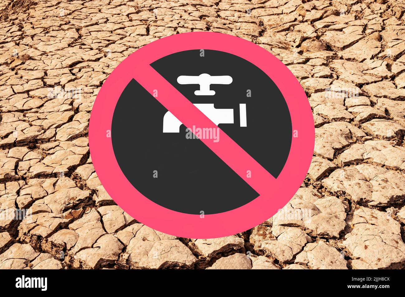 Dry reservoir, lake, cracked earth with hosepipe, water, tap prohibited sign. Global warming, climate crisis, drought... uk Stock Photo