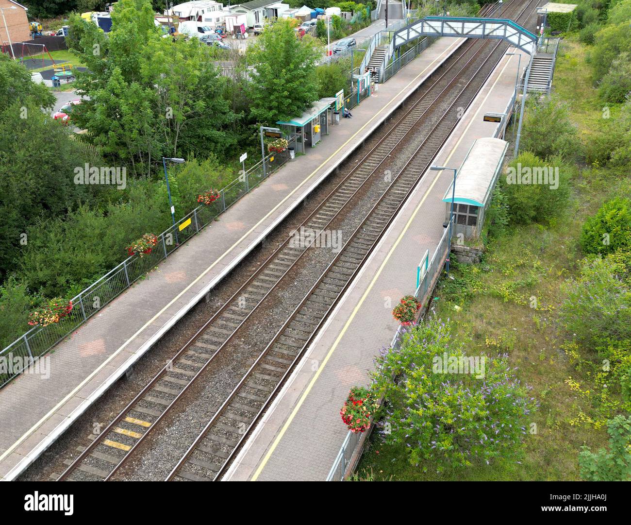 Pontyclun, Wales - July 2022: Aerial view of the railway station in the village of Pontyclun in Rhondda Cynon Taf in south Wales. Stock Photo