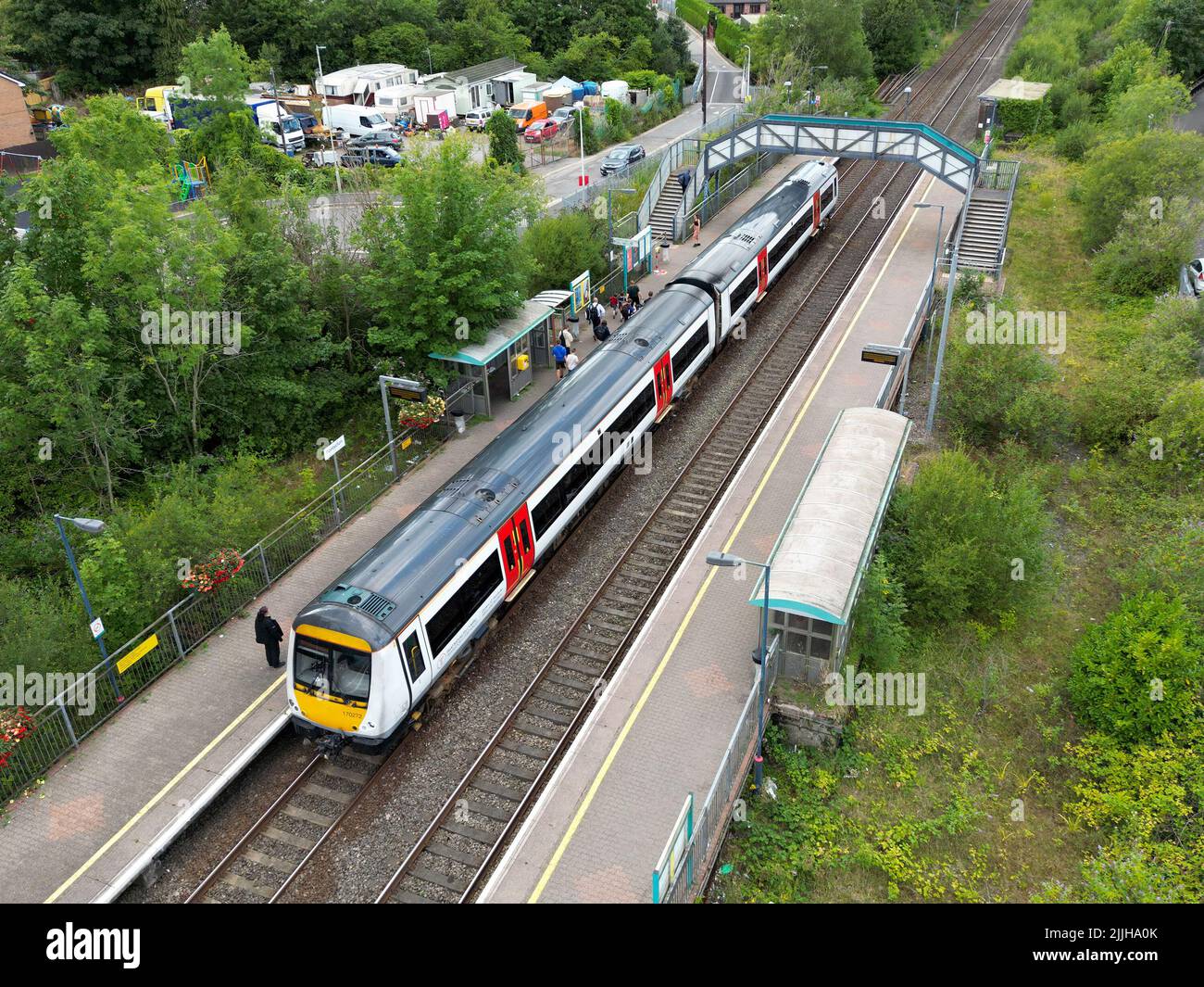 Pontyclun, Wales - July 2022: Aerial view of people getting off a train at the railway station in the village of Pontyclun in south Wales Stock Photo