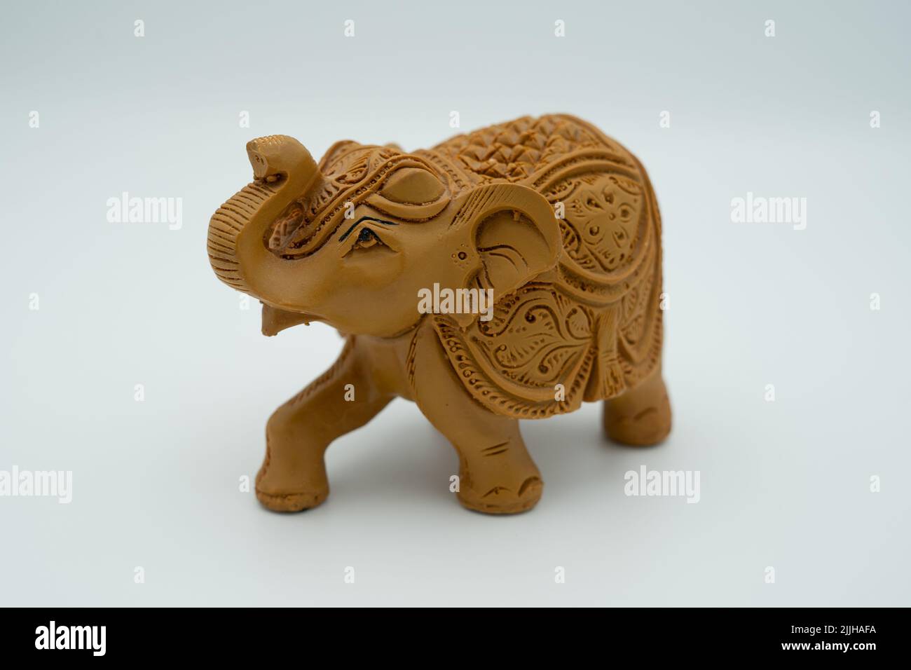A closeup shot of an Indian-style carved elephant statue isolated on the white background Stock Photo