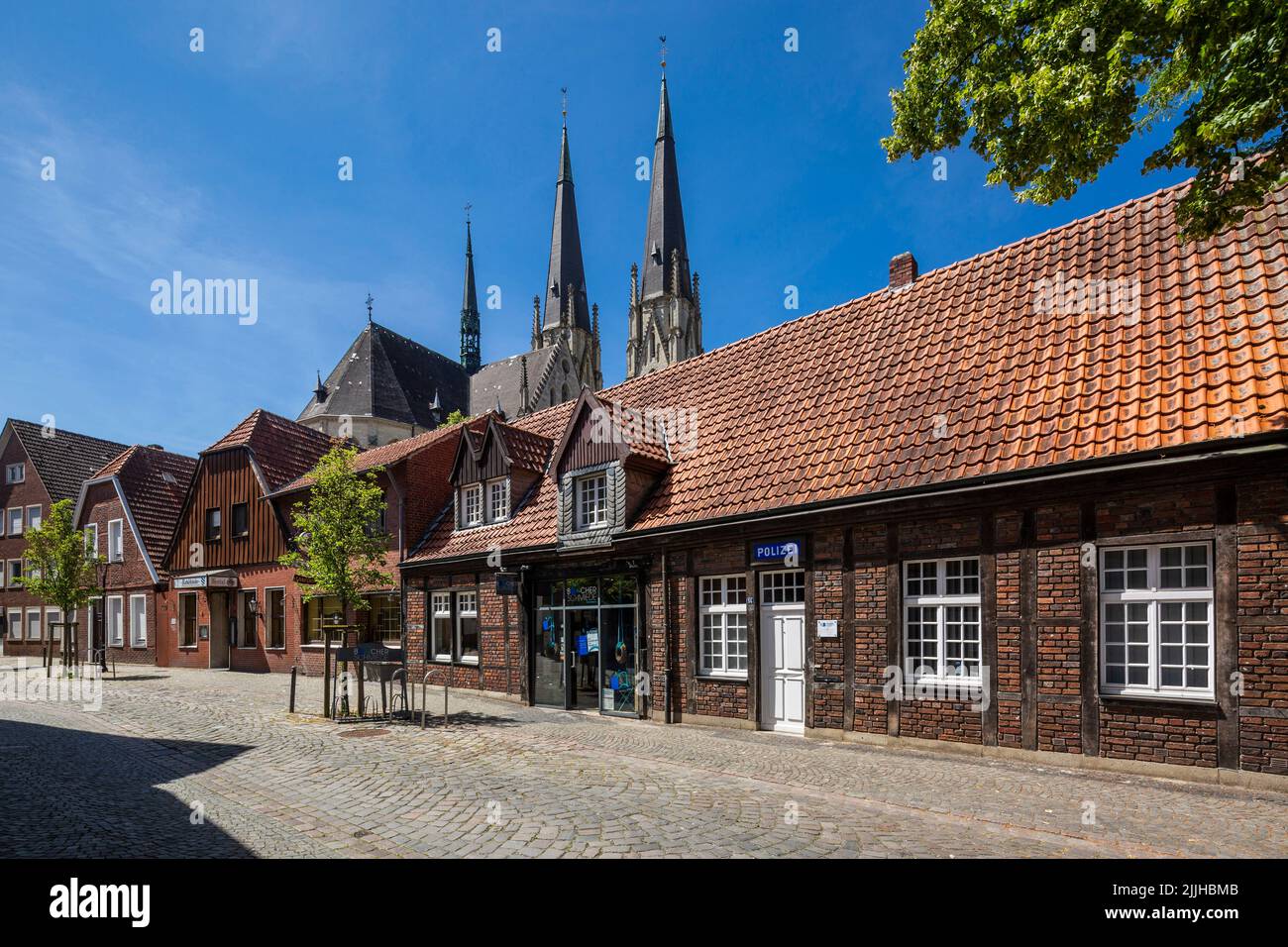 Germany, Billerbeck, Berkel, Baumberge, Muensterland, Westphalia, North Rhine-Westphalia, NRW, row of houses in the Schmiedestrasse, police station, half-timbered house, behind the provost church Saint Ludgerus, Ludgeri Cathedral, catholic church, pilgrimage church, Gothic Revival Stock Photo
