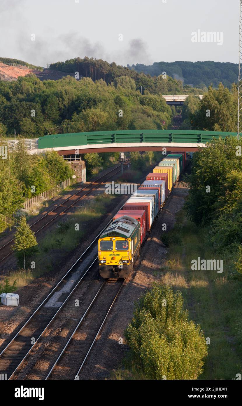 Freightliner class 66 diesel locomotive 66598 passing Bennerley in the Erewash valley, Nottinghamshire, UK with a freight train carrying containers Stock Photo