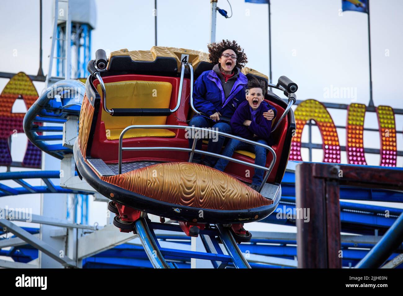 A woman with a child enjoying a ride in the Hoppings on the Town Moor Stock Photo