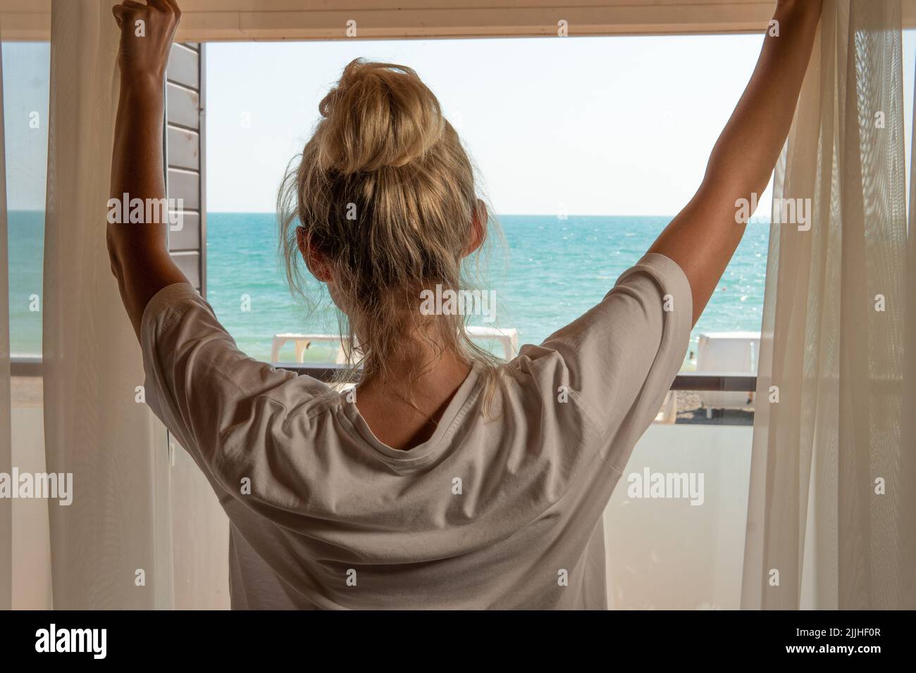 Sea curtains window woman home open morning back opening person, from light apartment in healthy for young hope, relax beauty. Rear lady alone, Stock Photo