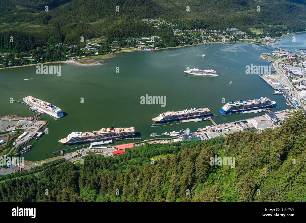 Juneau, AK - 9 June 2022: Overhead view of five cruise ships in port of Juneau with Viking Orion anchored in the bay. Stock Photo