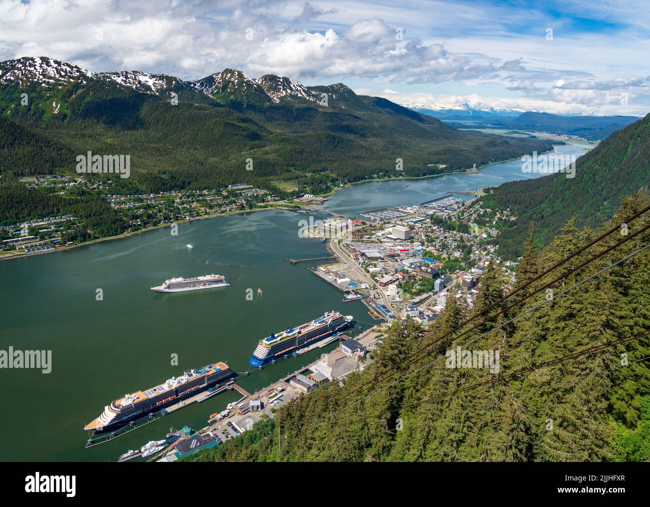 Juneau, AK - 9 June 2022: Overhead view of three cruise ships in port of Juneau with Viking Orion anchored in the bay. Stock Photo
