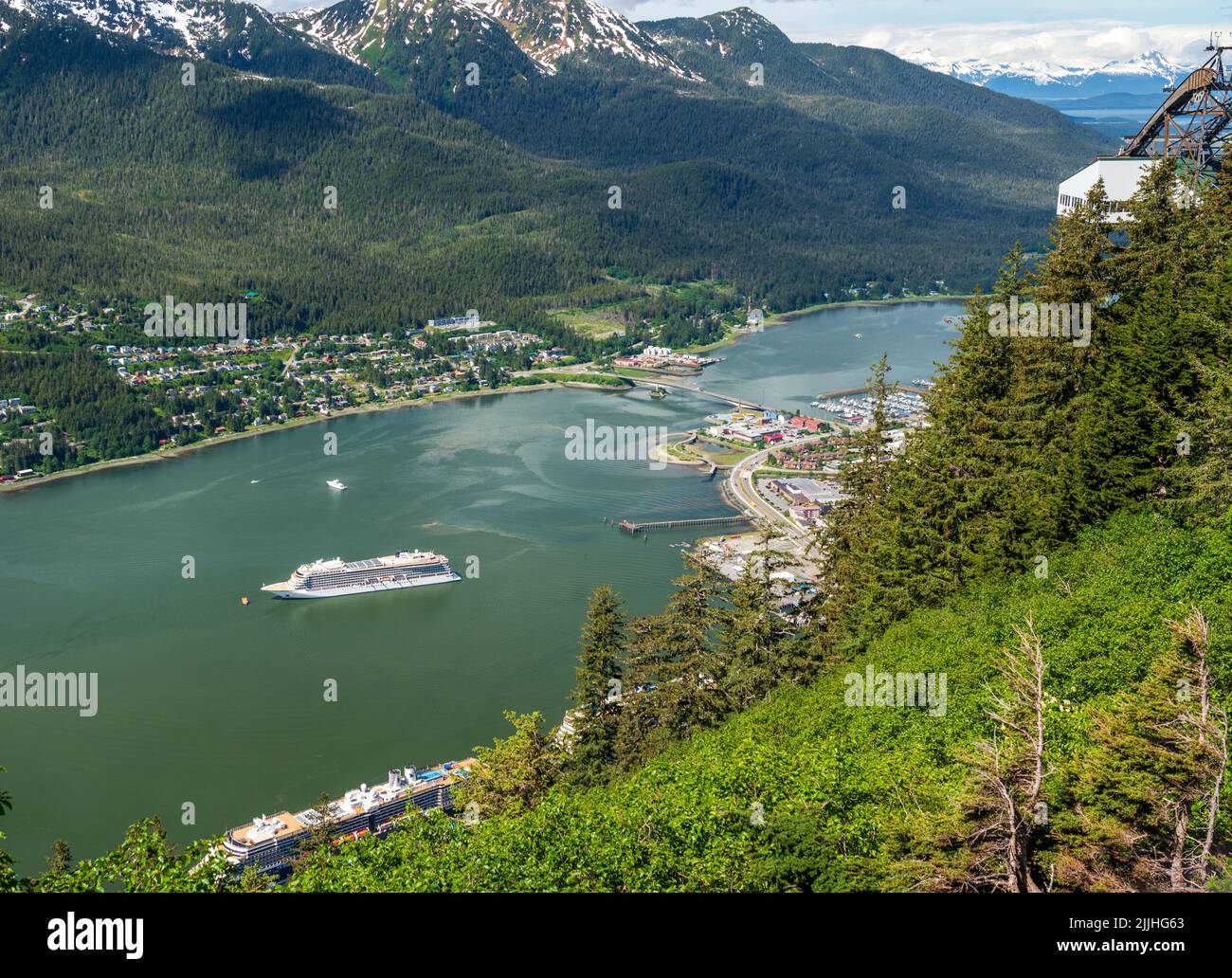 View of the port of Juneau in Alaska with cruise ships docked and anchored in the bay as seen from Mt Roberts Stock Photo