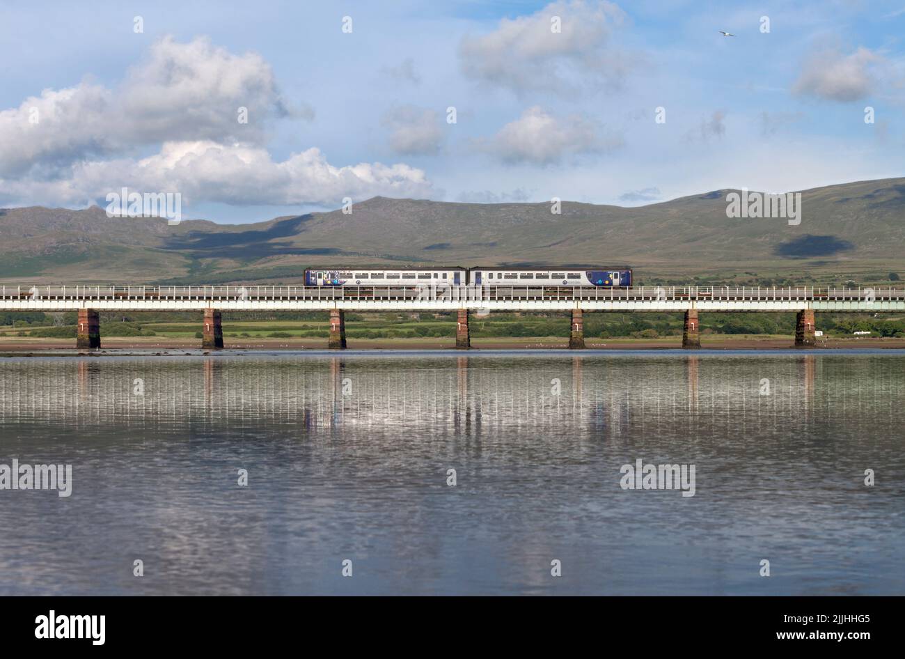Northern Rail class 156 sprinter train crossing Eskmeals viaduct on the scenic rural Cumbrian coast railway line Stock Photo