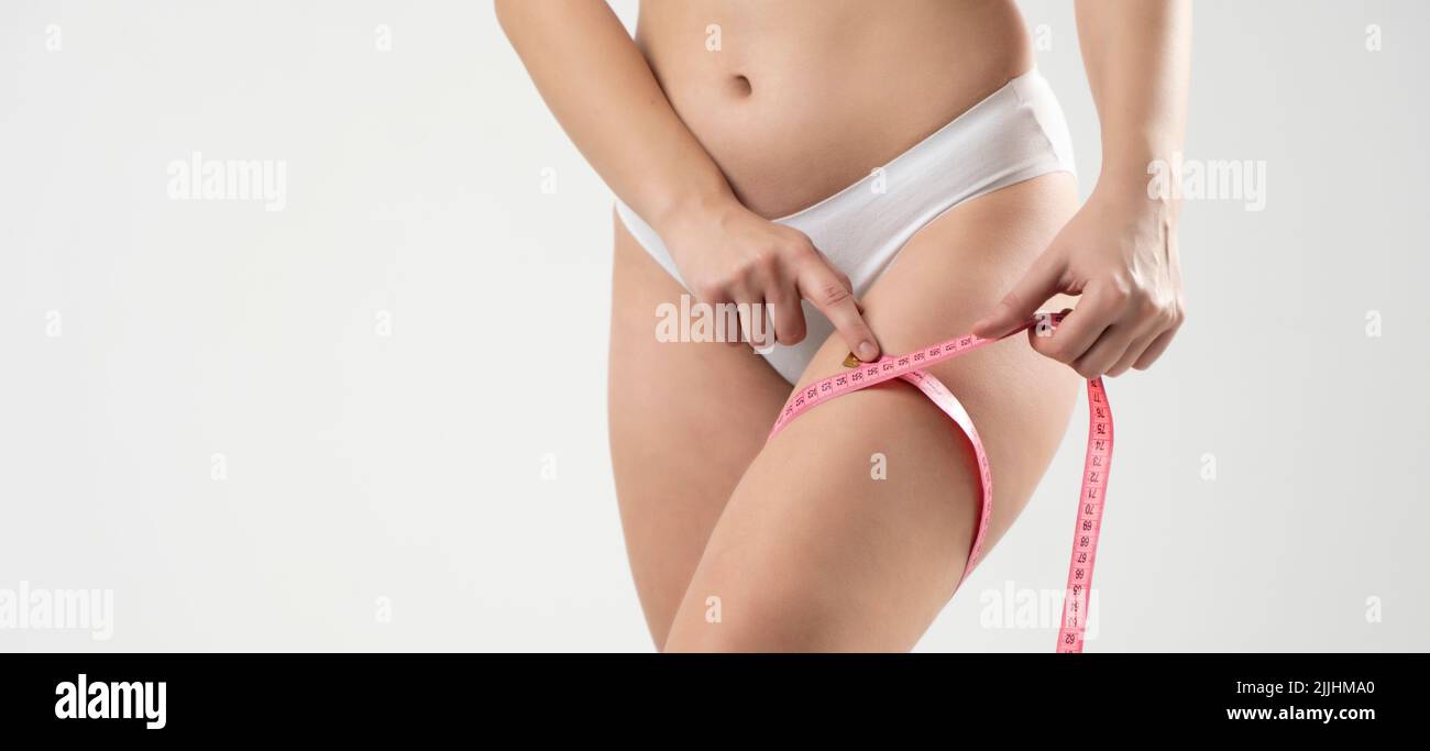Slim woman wearing pink panties Stock Photo