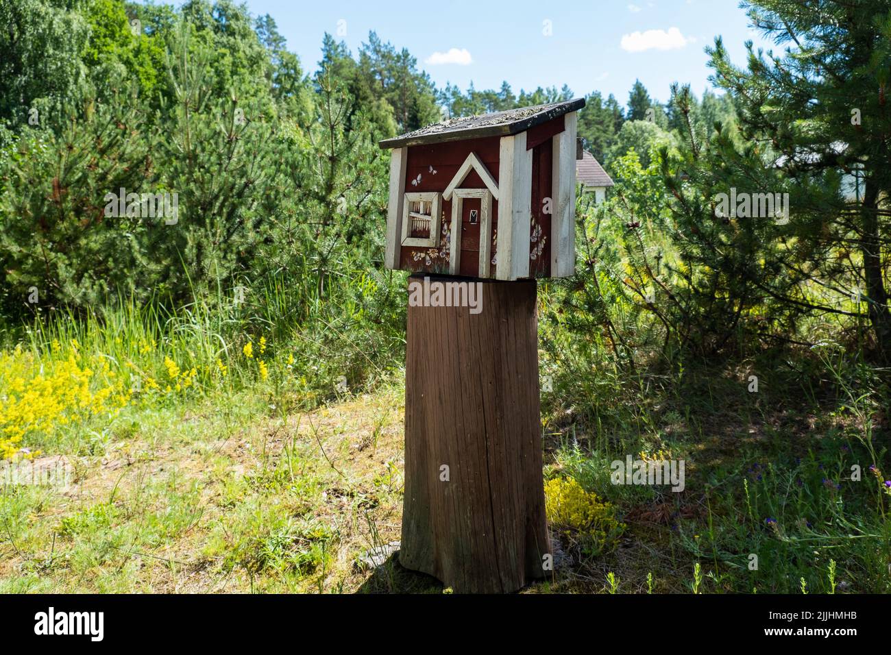 Creative mailbox in rural area. Post delivery and postal service in countryside concept. Stock Photo