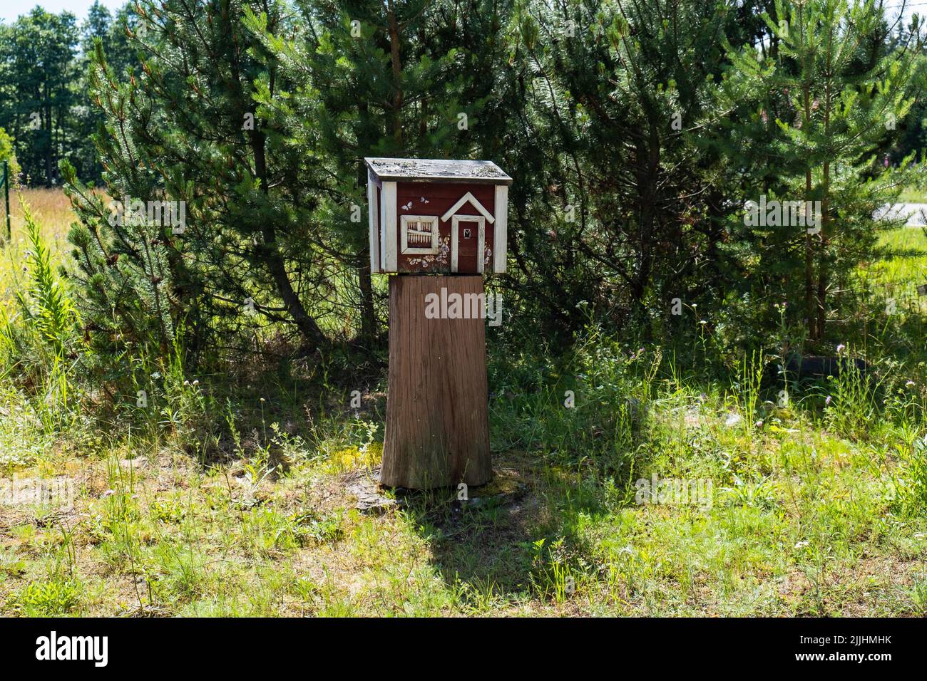 Creative mailbox in rural area. Post delivery and postal service in countryside concept. Stock Photo