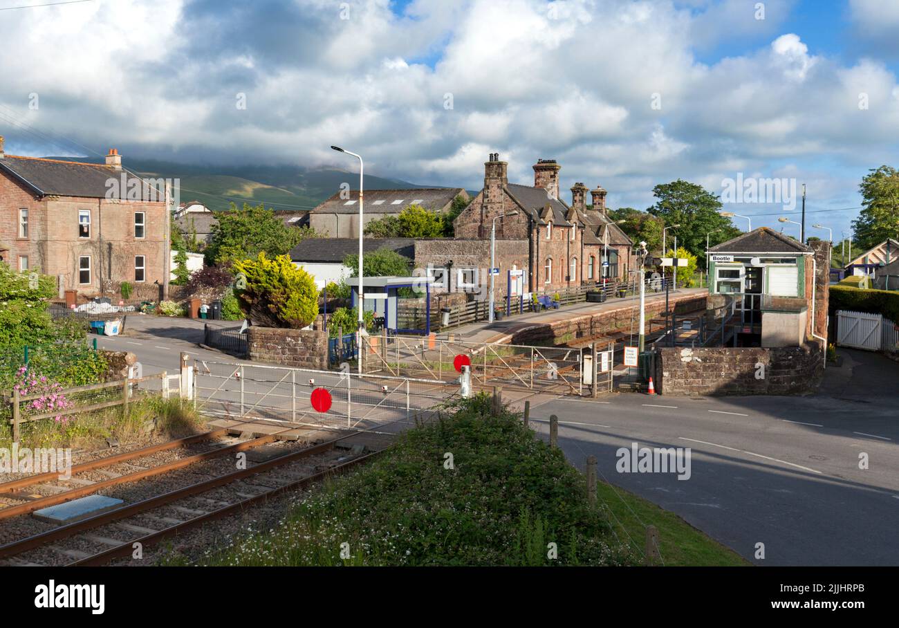 The village railway station at Bootle, Cumbria with manual level crossing gates and mechanical signal box on the Cumbrian coast railway line Stock Photo