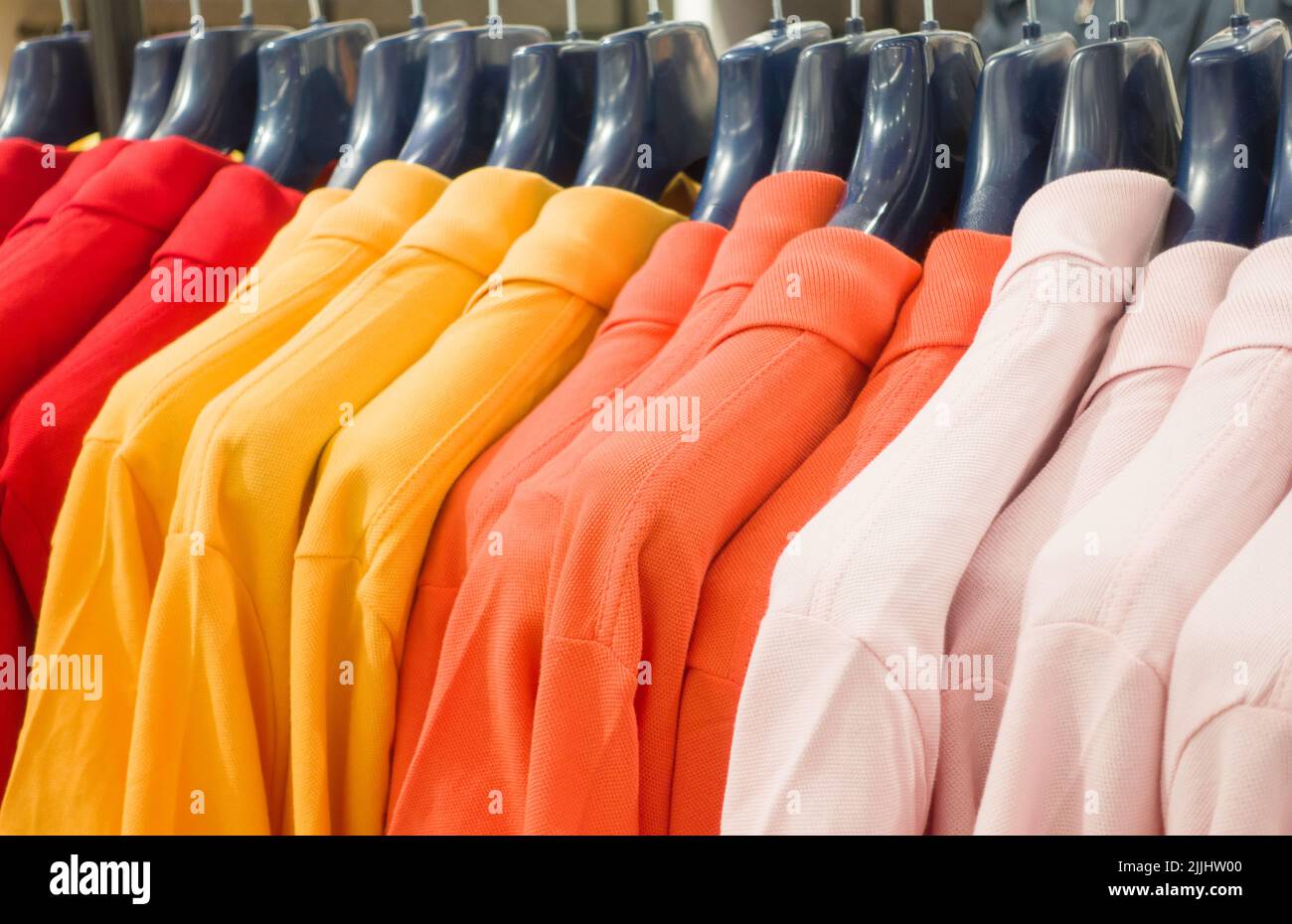 Colorful clothes on hangers in a retail shop Stock Photo Alamy