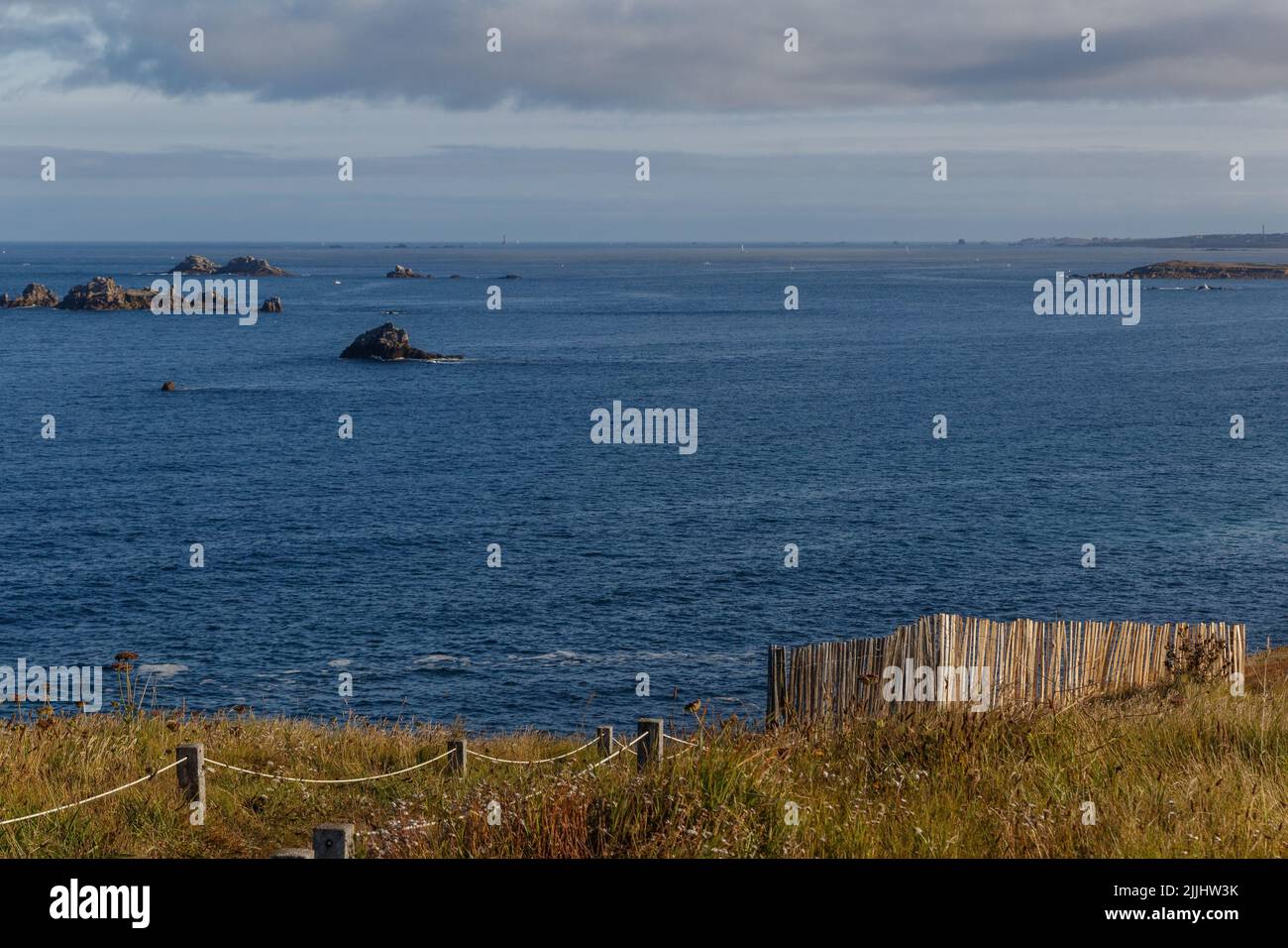 A beautiful view of greenery landscape with the blue sea under cloudy ...