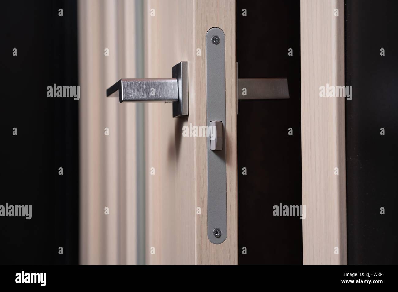modern and secured metal door handle and latch detail Stock Photo Alamy