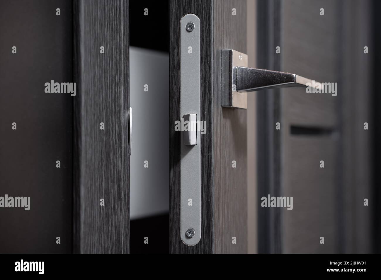 modern and secured metal door handle and latch detail Stock Photo Alamy