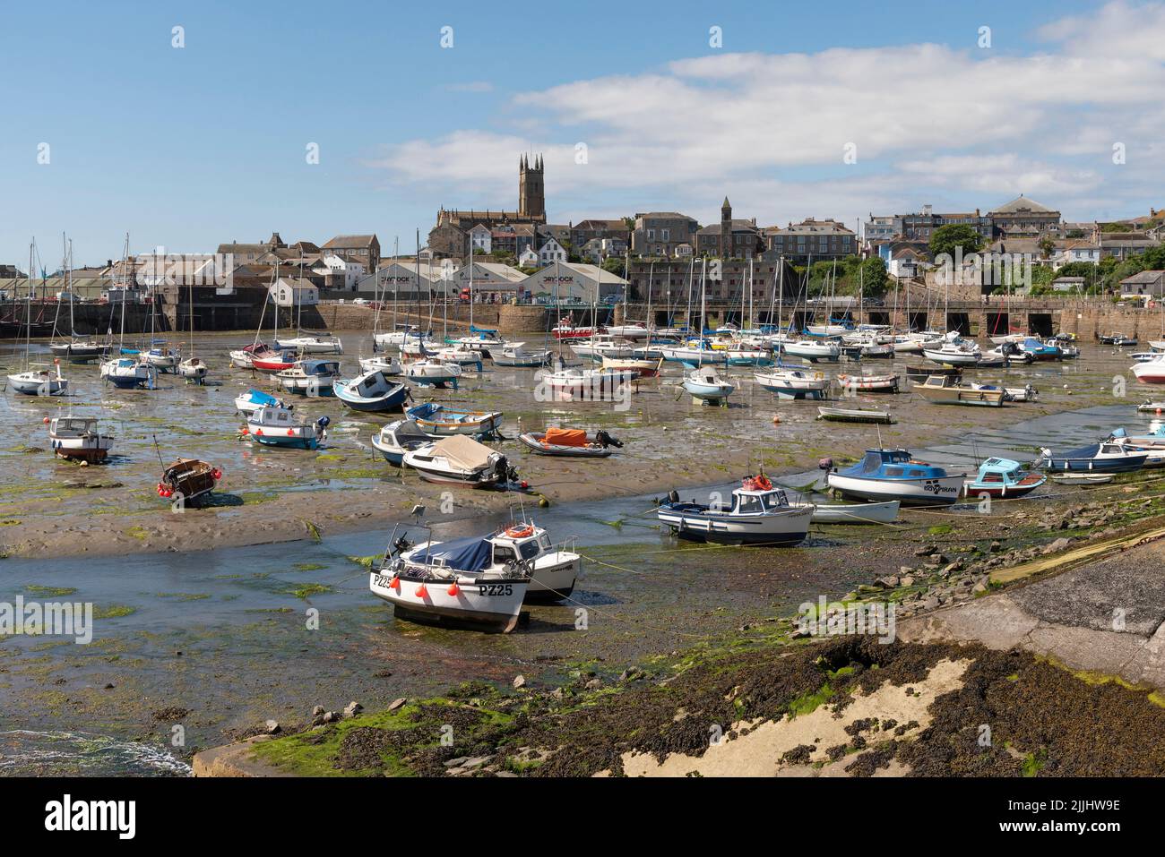Penzance, Cornwall, England, UK. 2022. Penzance Harbour with boats settled on the mud with a backdrop of the town centre. Cornwall UK. Stock Photo