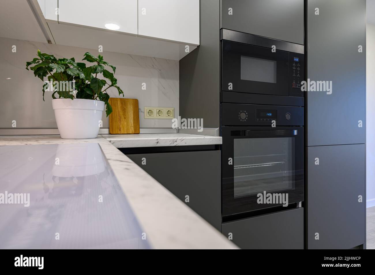 Marble worktop of modern white and dark grey kitchen Stock Photo Alamy