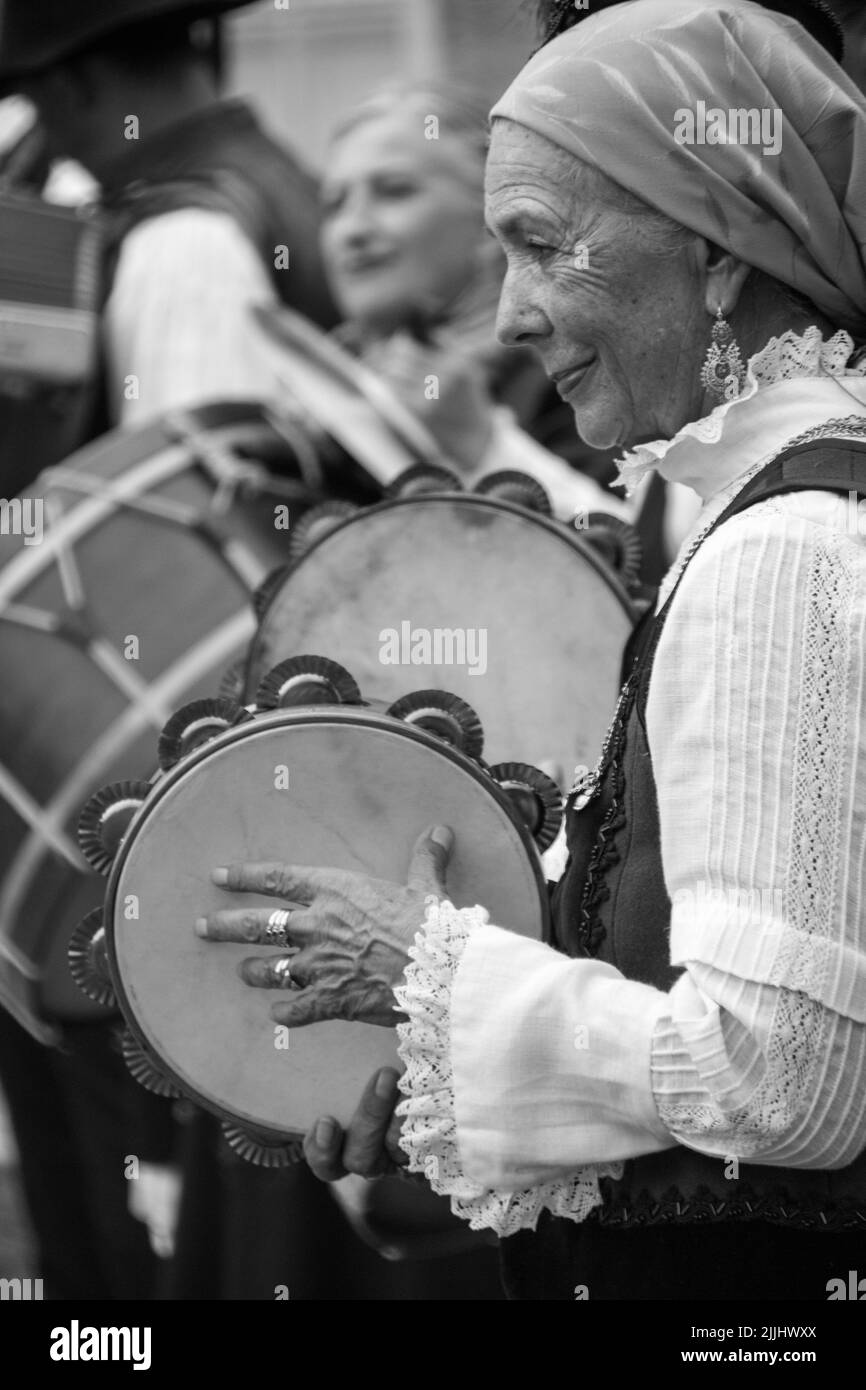 A monochrome shot of the traditional Galician woman playing a musical instrument Stock Photo