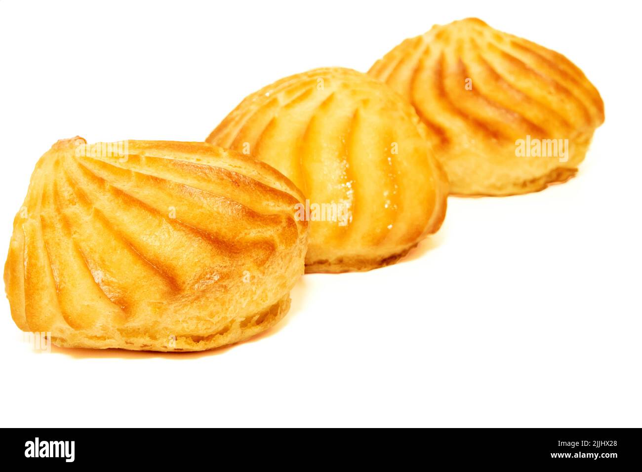 Three delicious appetizing profiterole eclair cakes on a white background Stock Photo