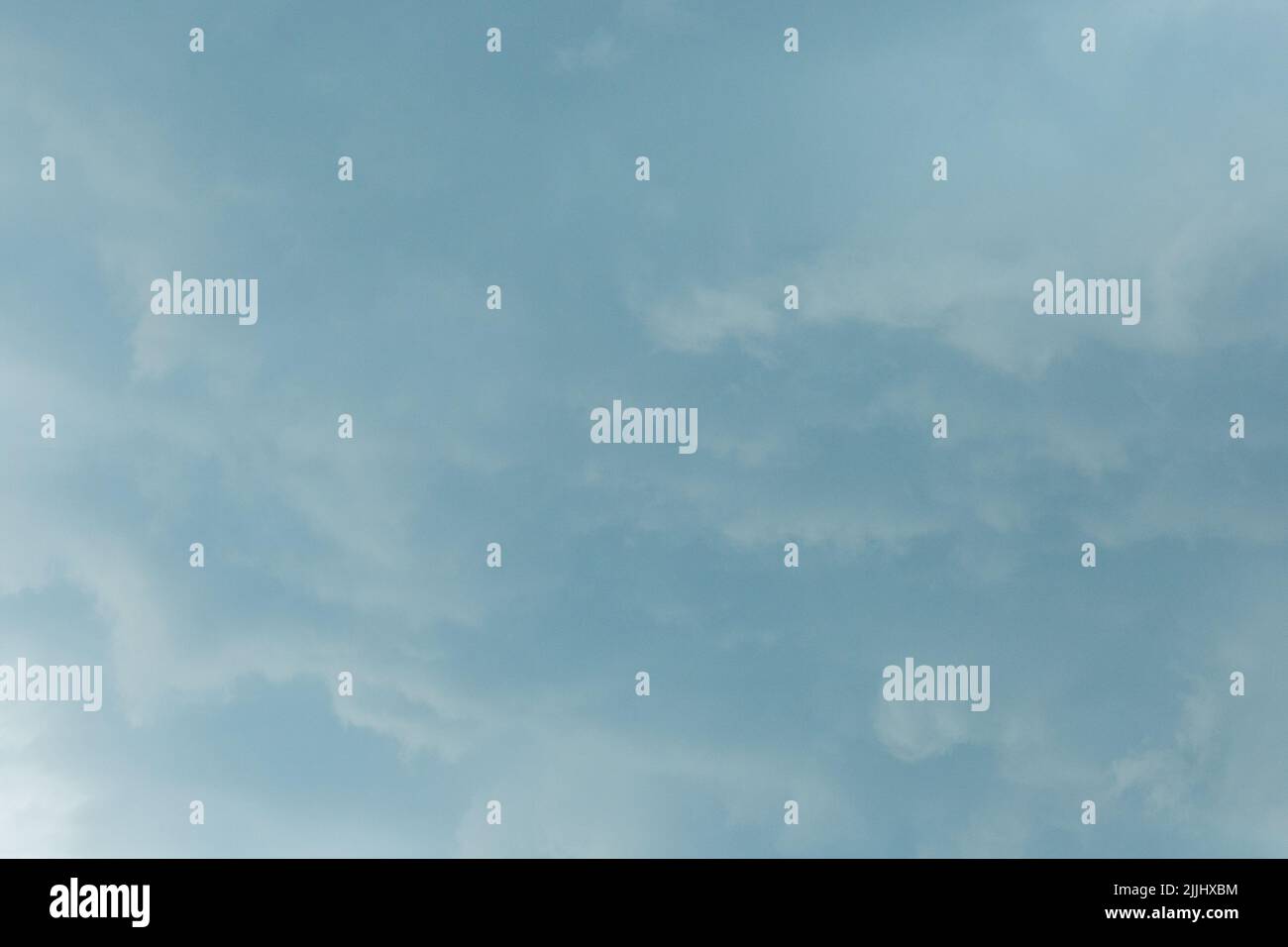 Light gray blue sky solid clouds rain weather change background nature. Stock Photo