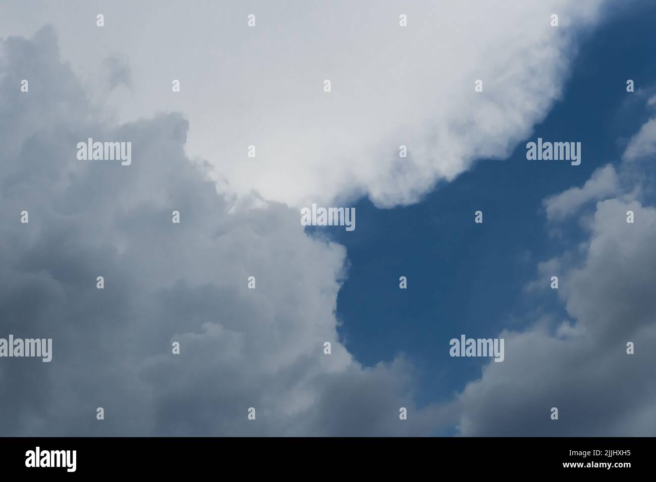Gray clouds cover the dark blue sky weather change bad weather rain clouds background nature. Stock Photo